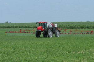 Crop sprayer in a grassy field
