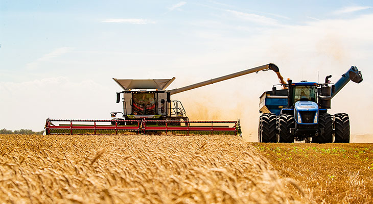 Combine and grain cart in a field during harvest